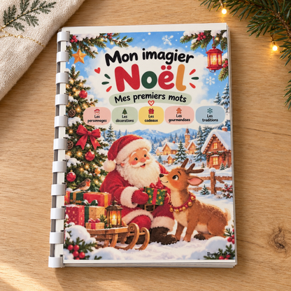 Couverture de Mon imagier Noël – Mes premiers mots, relié et posé sur une table en bois avec des branches de sapin.