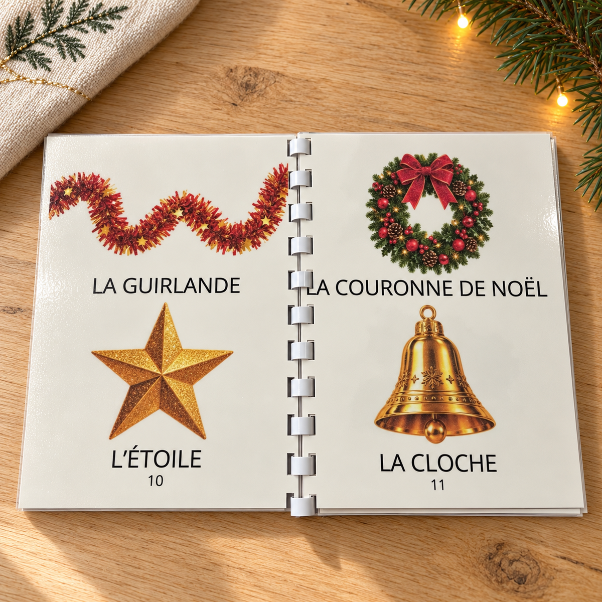 Imagier Noël ouvert aux pages 10 et 11 : guirlande, étoile, couronne de Noël et cloche.